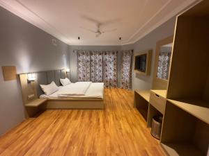 a bedroom with a bed and a large window at Silk Route in Srinagar
