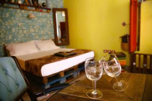 a bedroom with a bed and two glasses on a table at Famme sta cuiete appartamento Napoli centro in Naples