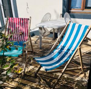 two chairs and a table on a patio at Studio séance sur l'oreiller in Malmerspach