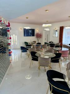 a dining room with tables and chairs in a room at Boutique Hotel Pošta RL in Oravský Podzámok