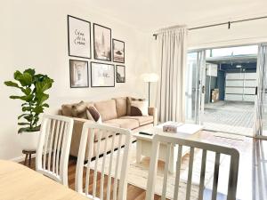 a living room with a couch and a table at Heartwarming 3BR-Townhouse in Broadview