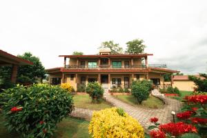 a house with a garden in front of it at Wild Adventure Resort in Sauraha