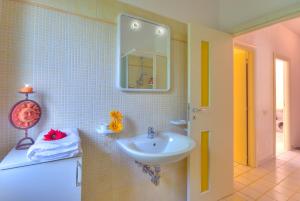 a bathroom with a sink and a mirror at Villaggio Riva Musone in Porto Recanati