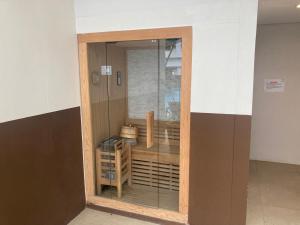 a glass door in a room with a shelf at By Trixia BE Apartments, Luxury Studio Apartments, AC, Pool, Gym, near IT Park in Cebu City +41 photos