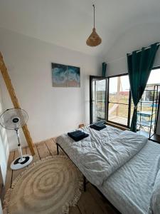 a bedroom with a bed and a large window at Summer Home Corbu in Corbu