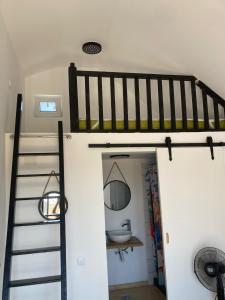 a room with a bunk bed and a staircase at Summer Home Corbu in Corbu