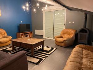 a living room with two chairs and a coffee table at Gîte 10 personnes Ardèche Jacuzzi in Saint-Apollinaire-de-Rias