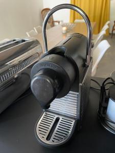 a toaster sitting on top of a table at Gîte 10 personnes Ardèche Jacuzzi in Saint-Apollinaire-de-Rias