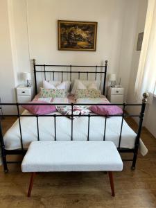 a black bed with a bench in a room at Apartament Piwna52 in Gdańsk