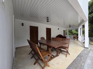 a wooden table and chairs on a patio at Wilpattu Corridor Leisure in Wilpattu