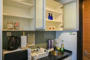 a kitchen with a sink and a counter top at Couple Suite at Casa Residency 5 mins walk to LRT, Jalan Alor & Bukit Bintang in Kuala Lumpur