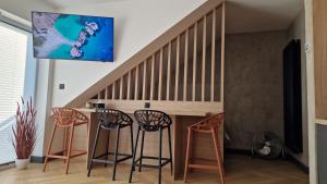 Una sala de estar con sillas y una mesa debajo de una escalera. en Kropla w morzu 12, en Darłowo