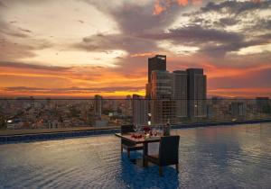a table and chairs on the edge of a building at Luxcity Hotel & Apartment in Phnom Penh