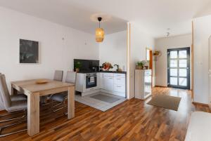 a kitchen and dining room with a wooden table in a room at Köthen Loft Apartment in Köthen