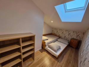 a small bedroom with a bed and a skylight at Verrines in Marigny