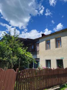 a house with a fence in front of it at Ailama Guesthouse in Mestia