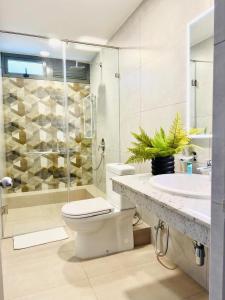 a bathroom with a toilet and a sink and a shower at C 1 Colombo Fort in Colombo