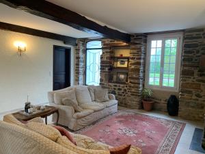 a living room with two chairs and a table at Maison Geze in Navarrenx