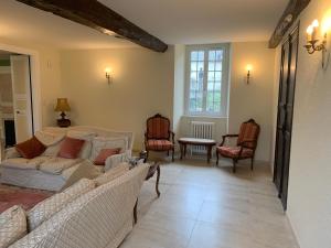 a living room with couches and chairs and a table at Maison Geze in Navarrenx