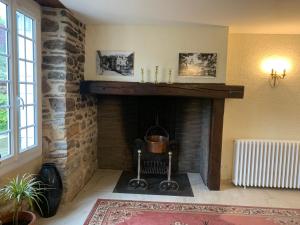 a living room with a brick fireplace with candles on it at Maison Geze in Navarrenx