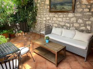 a patio with a couch and a table at Tiny House Fuma in Rovinj