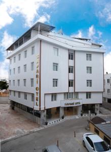 a large white building with a sign on it at Safari Otel in Antalya