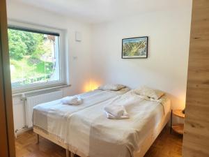 a bedroom with a bed with towels on it at Bella Bela Apartments 18A in Bled