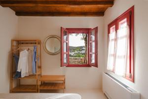 a dressing room with a mirror and a window at Avles Studio in Mélanes