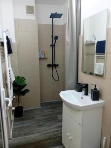 a bathroom with a sink and a mirror at Soft Apartments in Galaţi