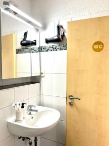 a bathroom with a sink and a mirror at Wohnung in Monheim am Rhein in Monheim +26 photos