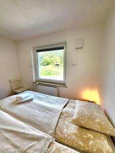 a bedroom with a large bed with a window at Bella Bela Apartments 18A in Bled