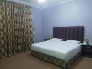 Postel nebo postele na pokoji v ubytování Al Jimi Plaza Hotel