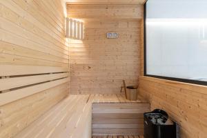 a wooden sauna with a large window in it at Apartamenty Małe Żywczańskie Lux&SPA in Zakopane
