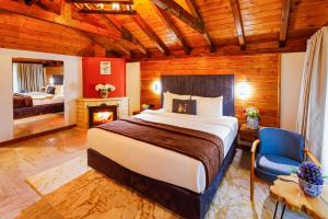 a bedroom with a bed and a chair and a fireplace at Abant Niz in Bolu