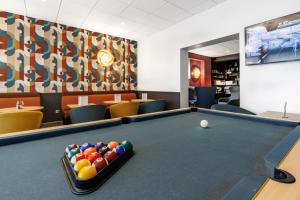 a billiard room with a pool table at The Originals Boutique, Hôtel Le Pariou, Issoire in Issoire