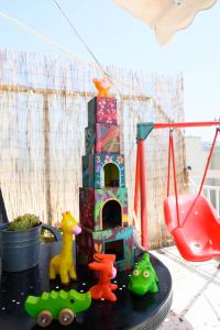 a table with a toy house and a playground at Hygge Home at Trikala in Tríkala