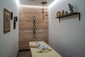 a hallway with a table and a wall at Tuzla Garden Hotel & Spa in Tuzla