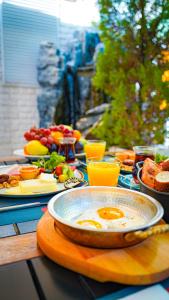 a table with an egg in a bowl of food at Tuzla Garden Hotel & Spa in Tuzla