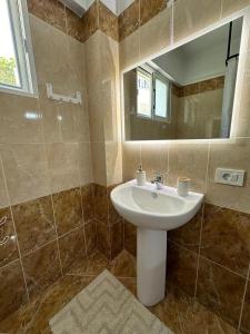 a bathroom with a sink and a mirror at SWEET HOME 1 in Himare