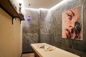 a room with a table and a painting on the wall at Tuzla Garden Hotel & Spa in Tuzla