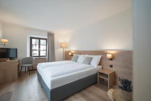 Postel nebo postele na pokoji v ubytování Hotel Brocco & Posta