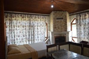 a bedroom with a bed and a fireplace at Koilada Çarpışantürk Konakları in Gokceada Town