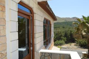 a door to a house with a view at Koilada Çarpışantürk Konakları in Gokceada Town