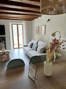 a living room with a couch and a table at El Torreón de Muro in Boltaña +43 photos