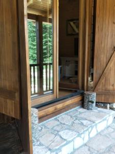 an open door to a porch of a house at Vila Bianka Žabljak Vikendica u selu Uskoci in Žabljak