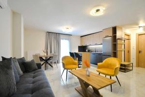 a living room with a couch and a table at Anemos Luxury Apartments in Leptokaria