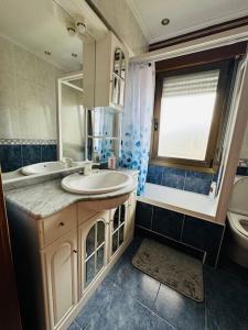 a bathroom with a sink and a toilet and a mirror at Muskiz Retreat, playa 5 mins, WIFI gratis in Muskiz