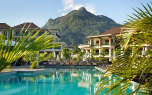 a large swimming pool in a tropical setting at Savoy Seychelles Resort & Spa in Beau Vallon