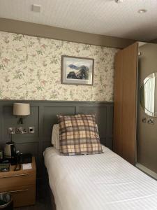 a bedroom with a bed and a picture on the wall at Royal Victoria Hotel Snowdonia in Llanberis