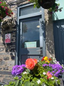a door with a bunch of flowers in front of it at Royal Victoria Hotel Snowdonia in Llanberis